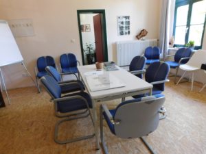 Seminarraum mit großem Tisch und Stühlen drumherum